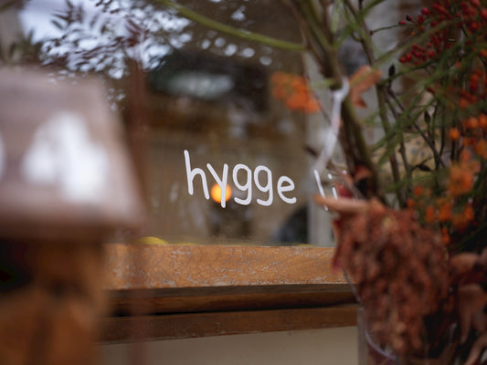 Hygge sign on a window with autumn decor